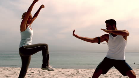 Athletes-doing-martial-arts-on-the-beach