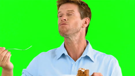 Man-savouring-a-delicious-cake-on-green-screen