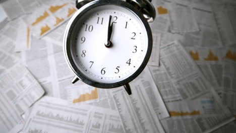Alarm-clock-falling-over-sheets-of-paper