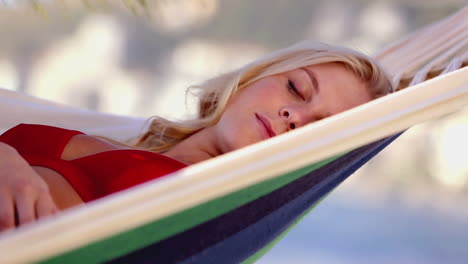 Pretty-blonde-woman-sleeping-on-a-hammock
