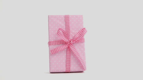 Hand-snatching-away-pink-present