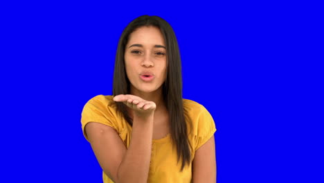Woman-blowing-a-kiss-on-blue-screen