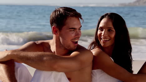 Attractive-couple-back-to-back-on-the-beach