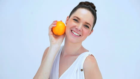 Beautiful-woman-holding-an-orange
