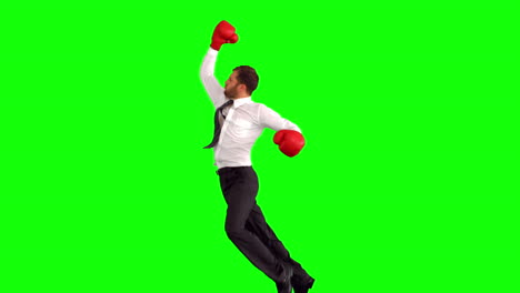 Businessman-leaping-with-boxing-gloves-and-punching