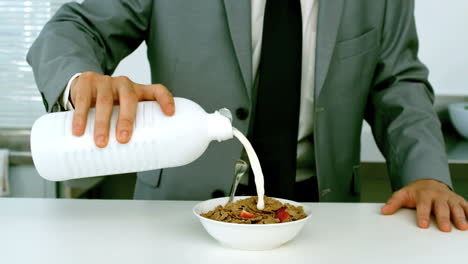 Businessman-pouring-milk-into-his-cereals