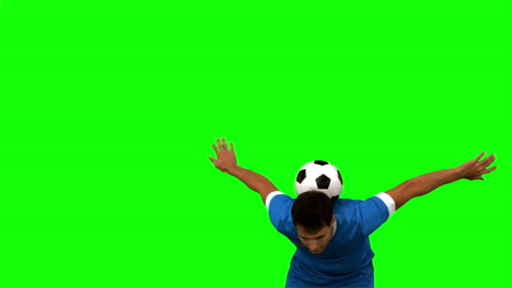 Man-juggling-a-football-with-head-on-green-screen-