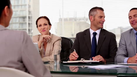 Cheerful-job-applicant-laughing-during-an-interview