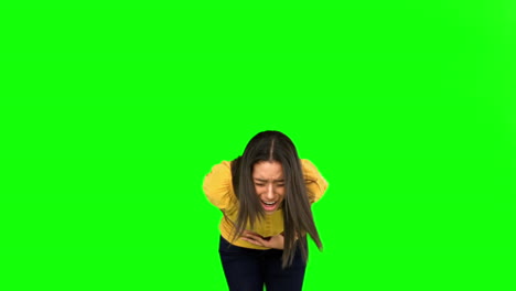 Woman-suffering-from-belly-pain-on-green-screen
