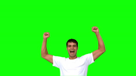 Cheerful-man-raising-arms-on-green-screen