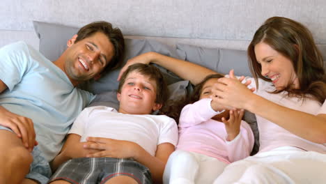 Happy-family-lying-in-a-bed