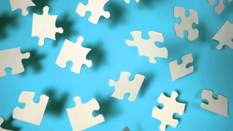 Jigsaw-puzzle-falling-on-blue-surface