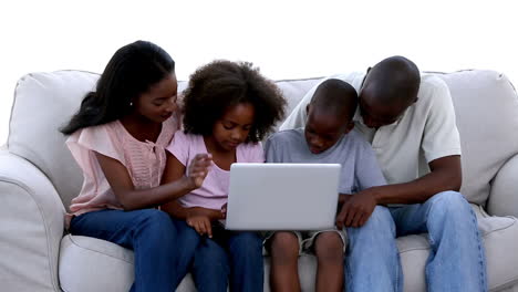 Family-with-laptop-on-a-sofa