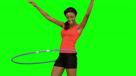 Woman-playing-with-a-hula-hoop-on-green-screen