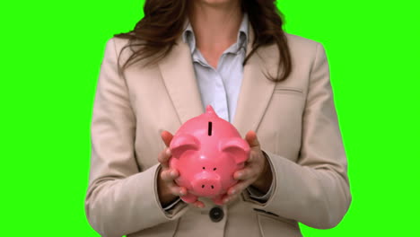 Businesswoman-throwing-a-piggy-bank-on-green-screen