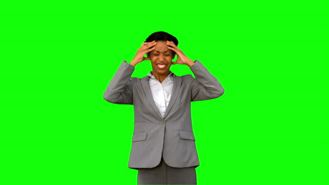 Furious-businesswoman-holding-her-head-on-green-screen