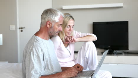 Couple-using-laptop-together-in-the-bedroom