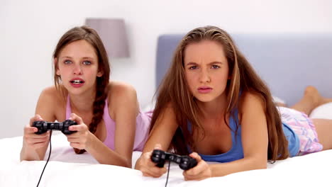 Girls-playing-video-games-on-bed
