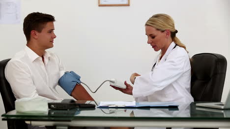 Female-doctor-checking-patient-blood-pressure