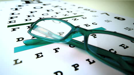 Green-reading-glasses-falling-onto-eye-test