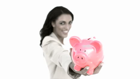 Businesswoman-holding-piggy-bank-