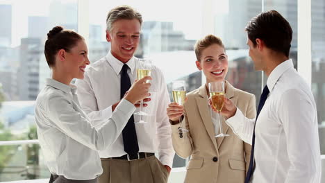 Cheerful-business-team-celebrating-with-champagne-