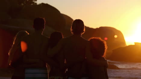 Silhouettes-of-friends-relaxing-while-looking-at-the-sunset