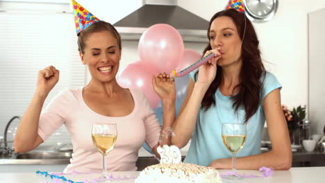 Women-wearing-party-hats-celebrating-birthday-together-