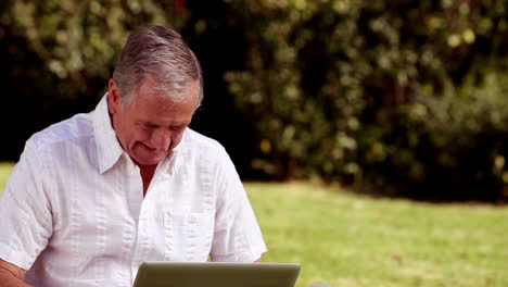 Elderly-man-sitting-in-a-park