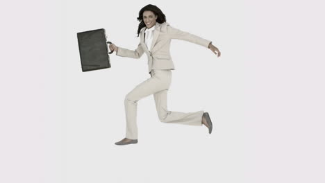 Businesswoman-jumping-in-the-air-with-her-suitcase-in-black-and-white