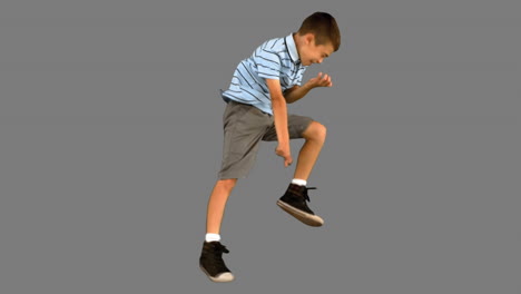 Little-boy-jumping-on-grey-screen