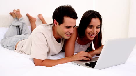 Delighted-couple-using-a-laptop