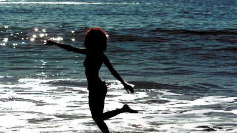Woman-dancing-while-she-is-into-the-sea
