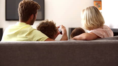 Rear-view-of-family-watching-tv