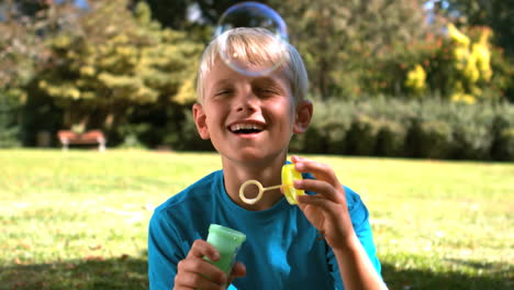 Young-boy-blowing-into-a-bubble-wand