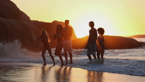 Silhouettes-of-friends-having-fun-on-the-beach