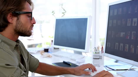 Serious-creative-man-working-on-his-computer