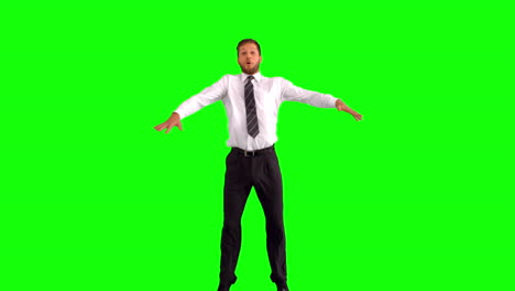 Businessman-jumping-and-stretching-his-body-towards-the-camera