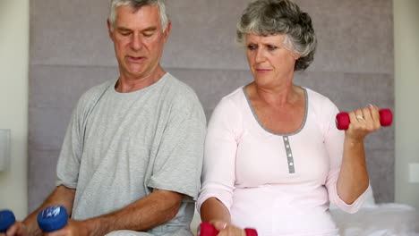 Mature-couple-doing-exercises