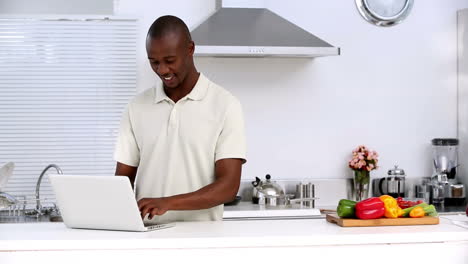 Man-with-laptop-in-a-kitchen