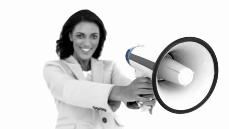 Businesswoman-showing-megaphone-to-the-camera-in-black-and-white-