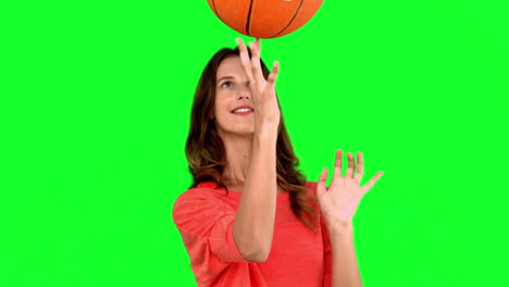 Woman-having-fun-with-a-basket-ball-on-green-screen