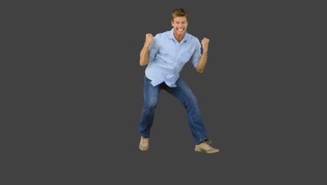 Man-jumping-to-show-his-triumph-on-grey-screen