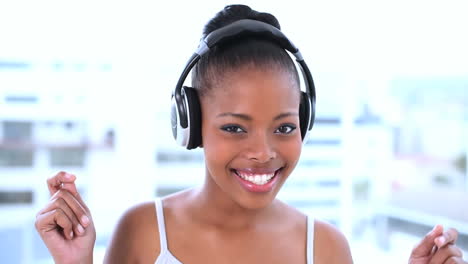 Smiling-beautiful-model-listening-to-music