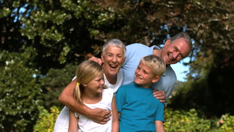 Cheerful-multigeneration-family-embracing-in-a-park