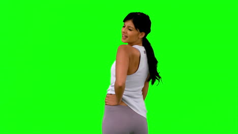 Woman-in-sportswear-turning-against-green-screen