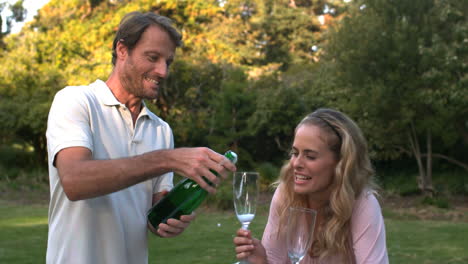 Handsome-man-opening-a-bottle-of-champagne