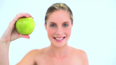 Pretty-woman-holding-a-green-apple-in-her-hand