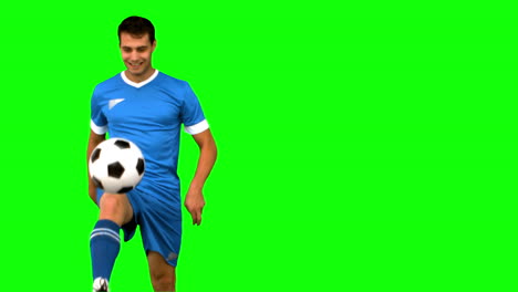 Man-playing-with-a-football-on-green-screen