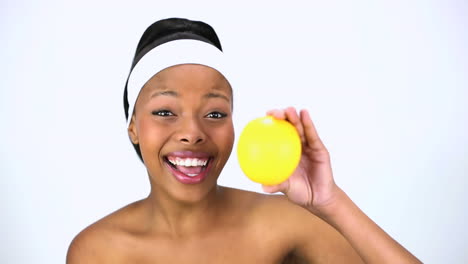 Cheerful-woman-holding-orange